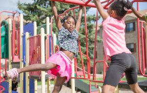 Girls playing on jungle gym low res